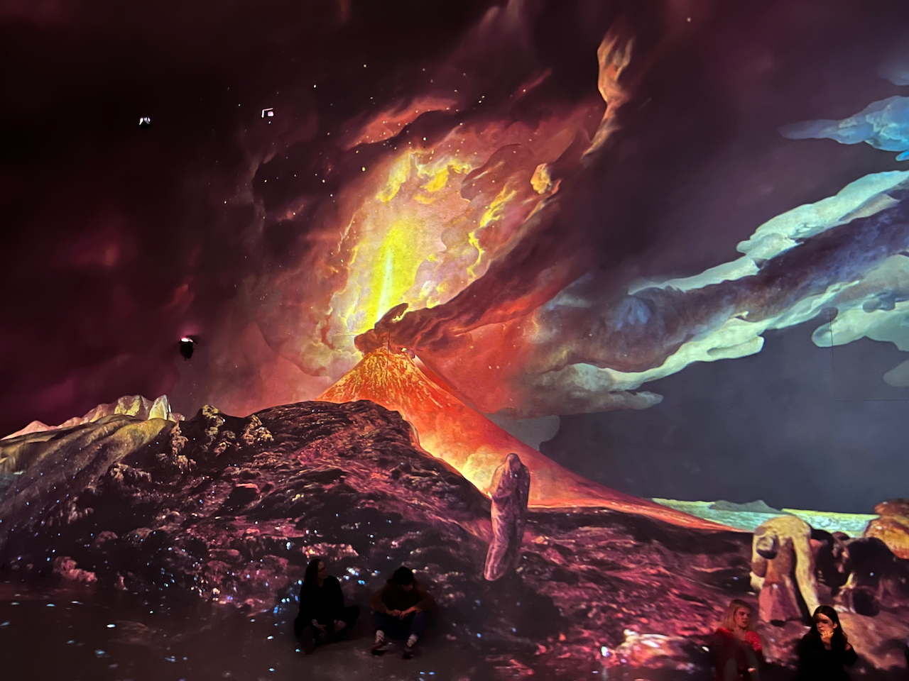 A painting of Vesuvius in Eruption, with a View over the Islands in the Bay of Naples by Joseph Wright of Derby, projected on to a huge wall in the Frameless gallery.