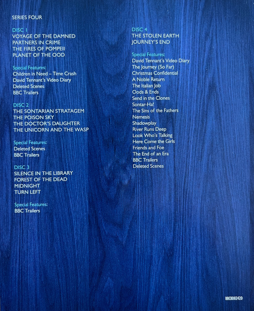 Rear side of the flyer included with the Doctor Who Series 4 Blu-ray Steelbook, showing the list of episodes and extras on each of the 4 discs, in white text over a close-up of the blue wood that makes up the exterior of the Tardis.