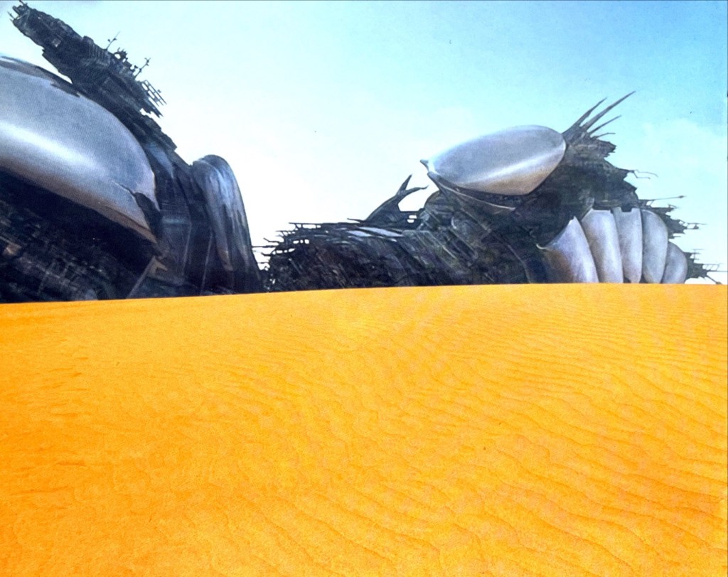 A huge spaceship in the middle of a desert.