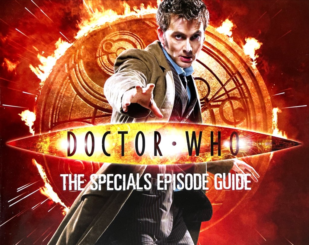 The cover of the Doctor Who 2008-2010 Specials Episode Guide booklet included with the original DVD release. It shows a photo of David Tennant's Doctor wearing a flowing brown jacket over a pinstripe suit, and reaching out towards us with his right hand, while behind him is a large golden circle covered in Gallifreyan symbols with flames erupting around the edge. Over the image is the Doctor Who logo and the title of the booklet in white text, The Specials Episode Guide.