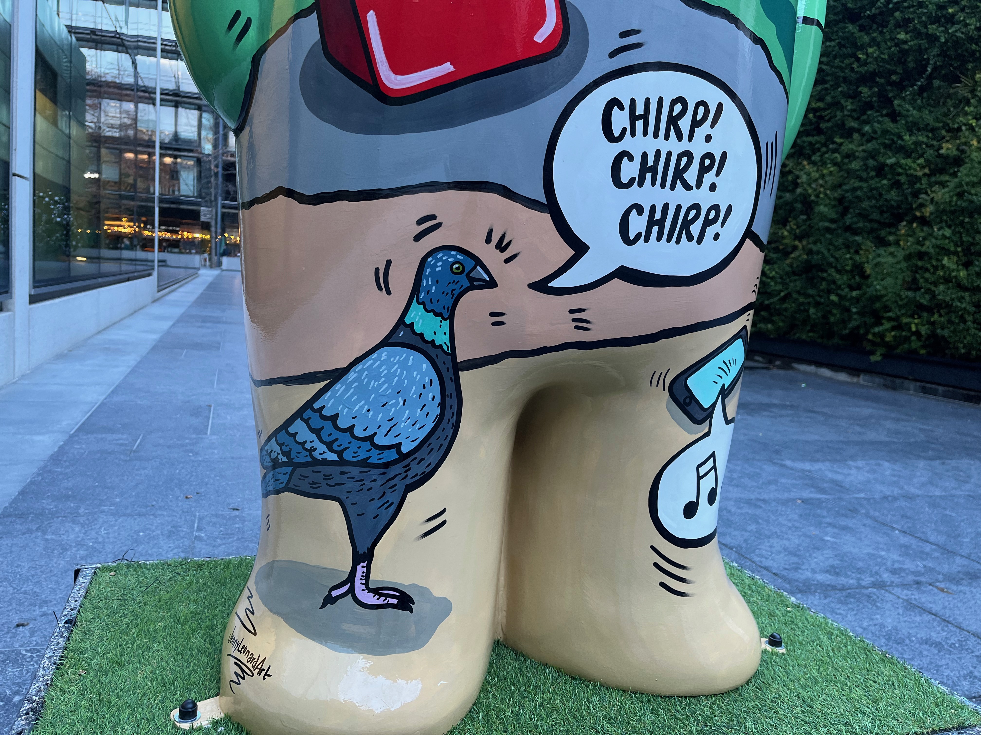 Close-up of a sculpture of The Snowman called Four Calling Birds, showing a pigeon-like bird going Chirp, Chirp Chirp.