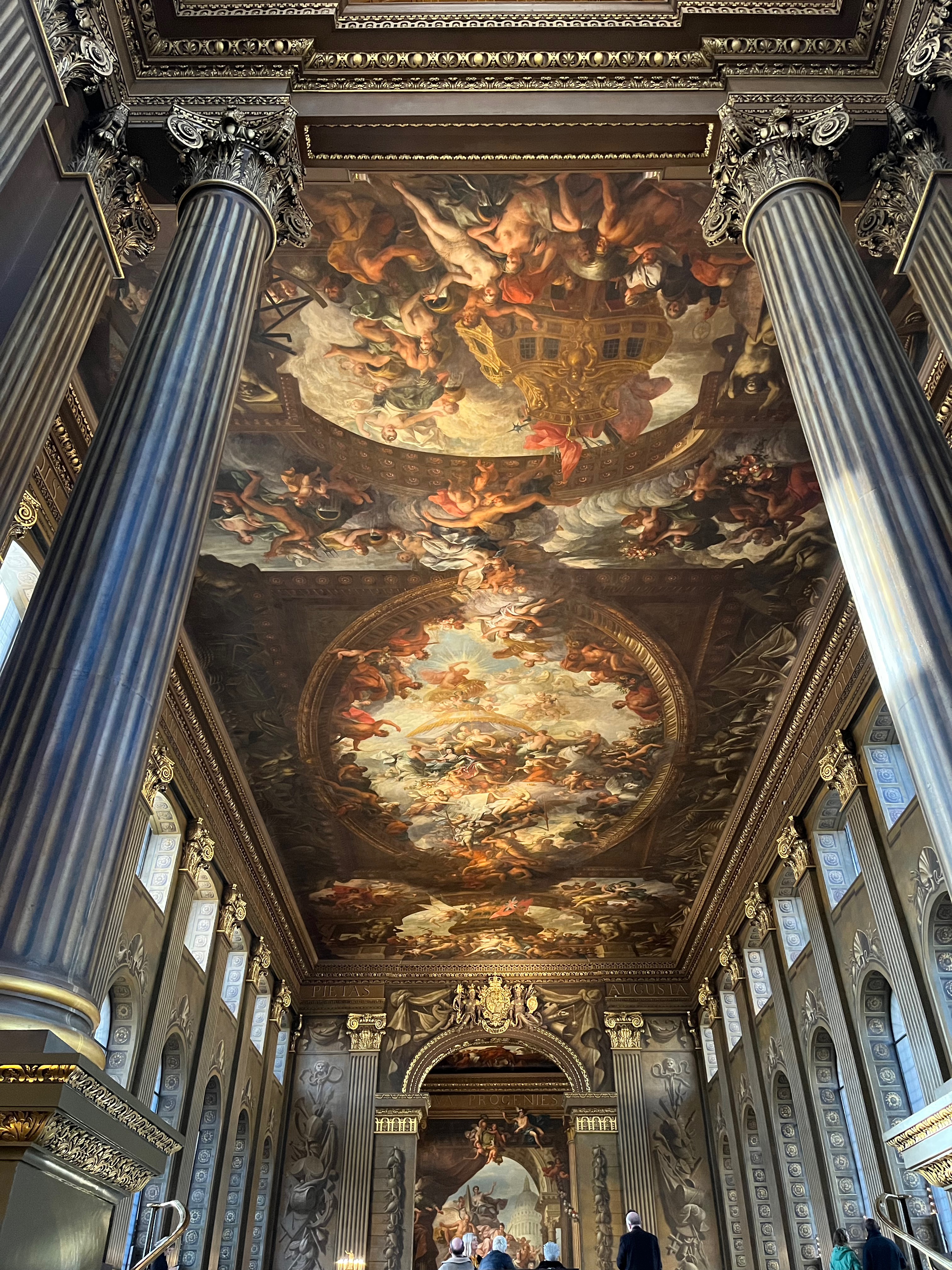 The Painted Hall in the Old Royal Naval College, with its arched windows along each side, and the long ceiling filled with highly detailed artworks.