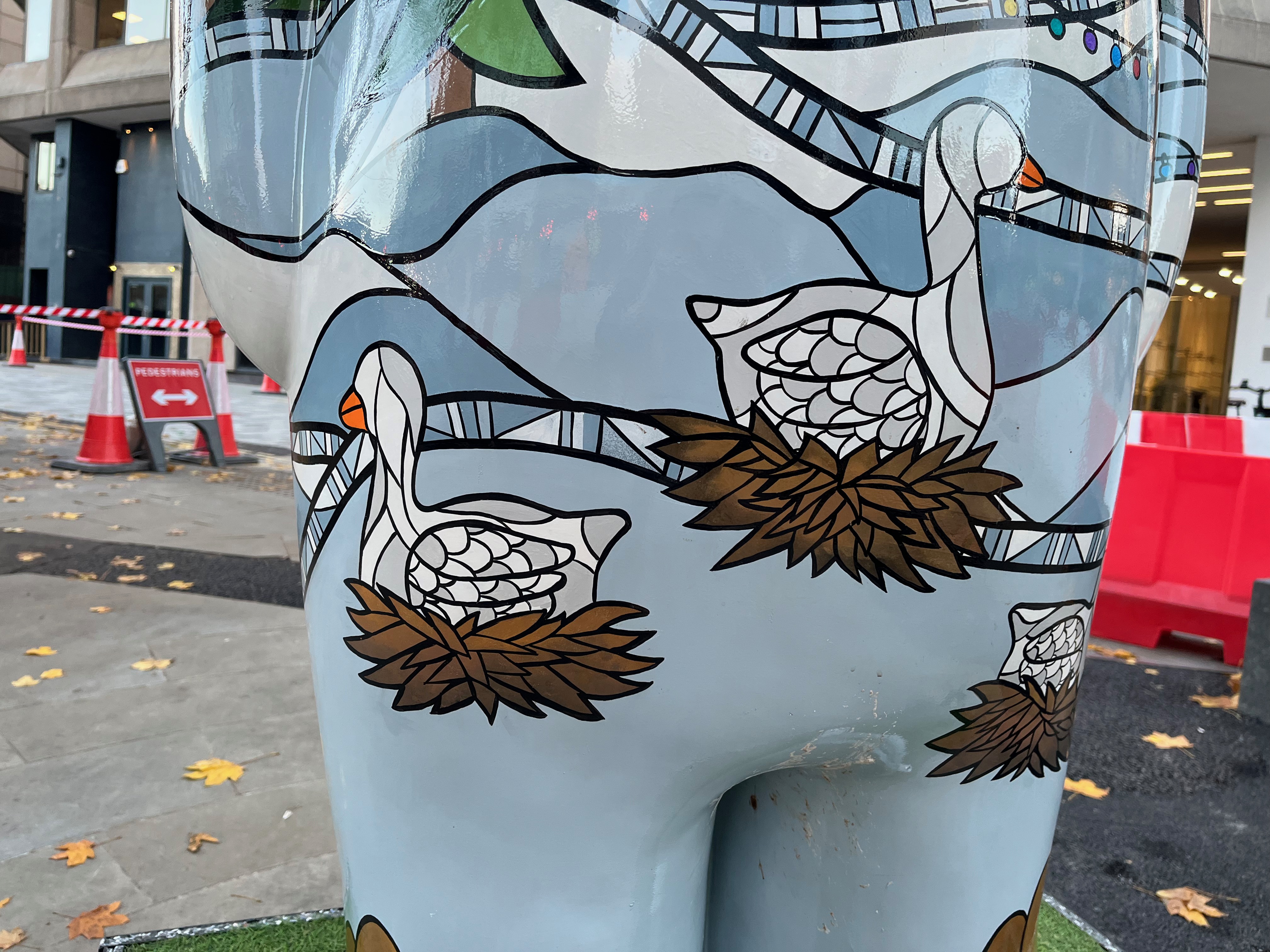 Close-up of two geese sitting on nests on the sculpture of The Snowman called Six Geese a-Laying.