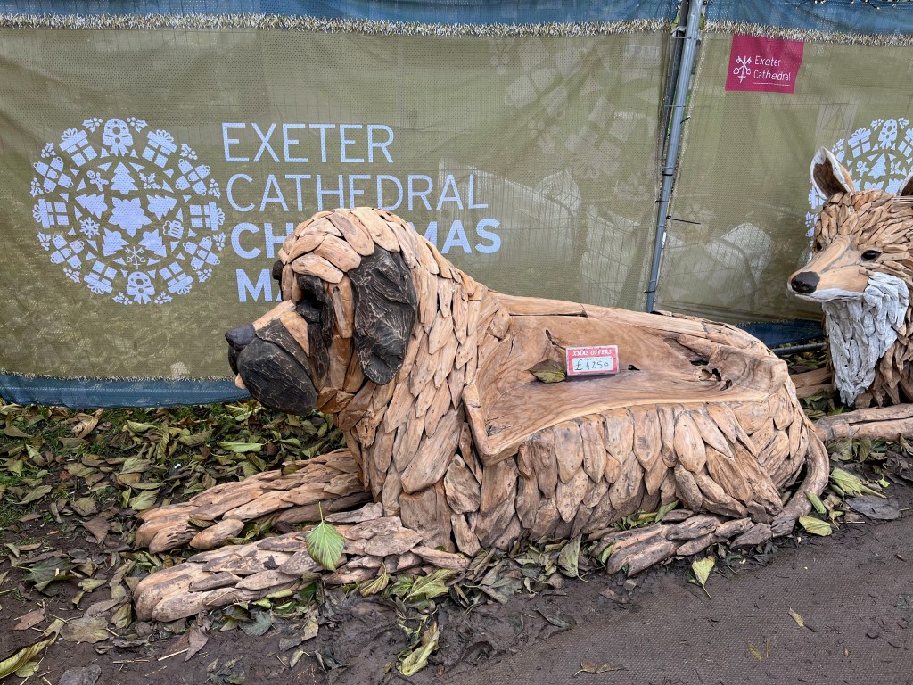 A large wooden model of a dog, on sale at the Exeter Cathedral Christmas Market.