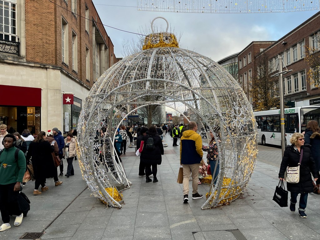 A large bauble-shaped structure on the High Street in Exeter that people can walk through.