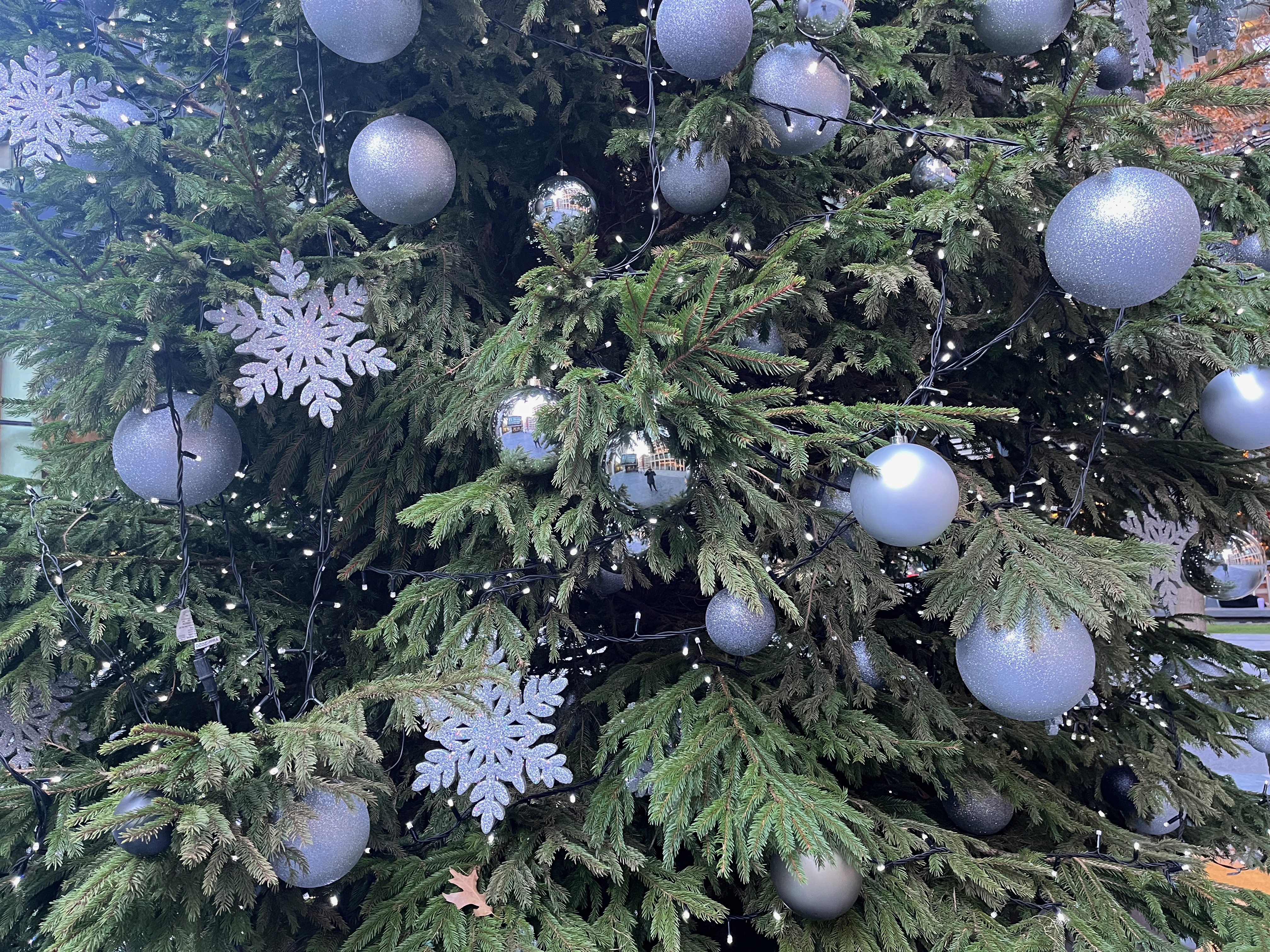 Close-up of the white snowflakes and silver baubles on the New Street Square Christmas tree.