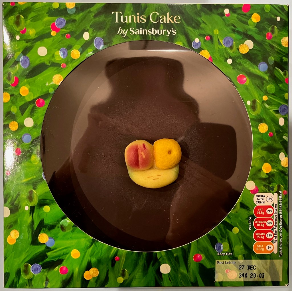 Sainsbury's Tunis Cake, a madeira sponge cake with a thick layer of chocolate on the top, in the centre of which is a cluster of 3 small marzipan fruits.
