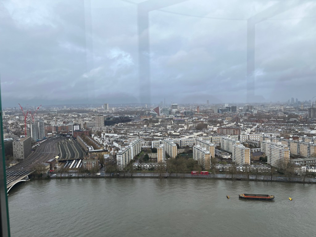 A high view across London from Lift 109 in Battersea Power Station, including lots of tall blocks of flats.