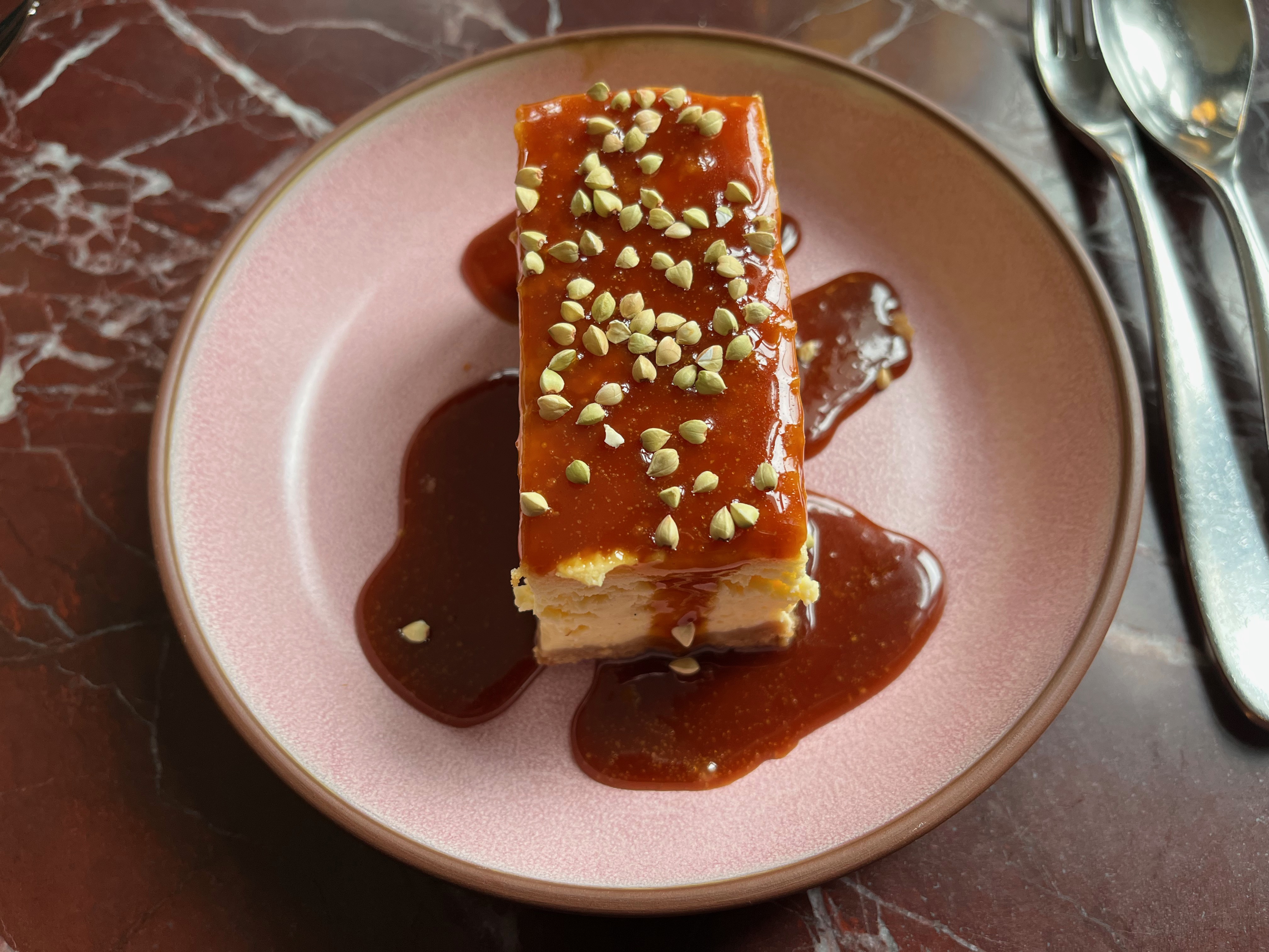 A baked cheesecake with Horlicks caramel sauce and lots of little crunchy biscuit bits on the top.