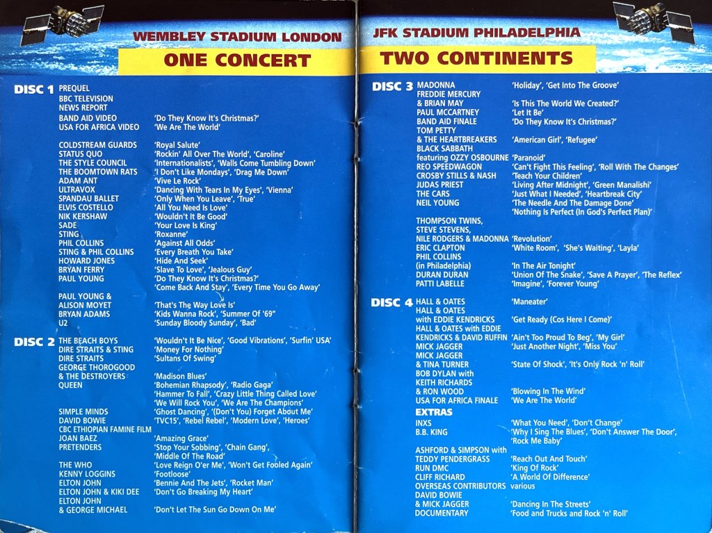 Double-page spread from the Live Aid DVD booklet, listing all of the performances and extras on the 4 discs, in white text on a blue background. At the top, over an image of the crest of planet Earth viewed from space, the header says Wembley Stadium London, JFK Stadium Philadelphia, One Concert, Two Continents.