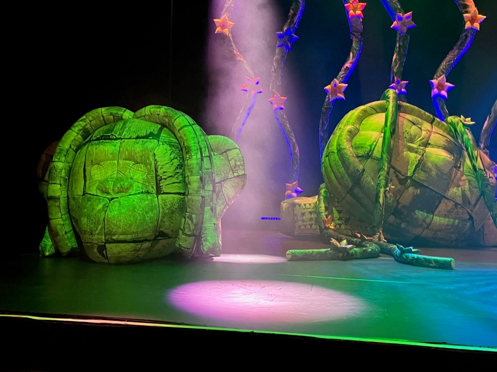 Two inflatable sculptures on the stage for Ross Noble's show Jibber Jabber Jamboree. They are designed to look like rocks carved into strange monkey-like heads.