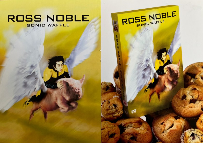 Two postcards accompanying Ross Noble's Sonic Waffle DVD. On the left postcard, Ross is riding on the back of a pig that has large white wings. The right postcard shows the DVD box stood among a selection of muffins. and the DVD box has the same cover image as on the left postcard.