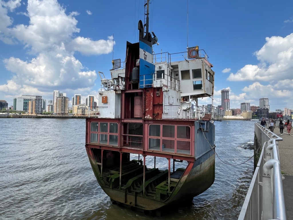 Public artwork called A Slice Of Reality by Richard Wilson that shows a life-size one-eighth slice of a sand dredger in the River Thames.