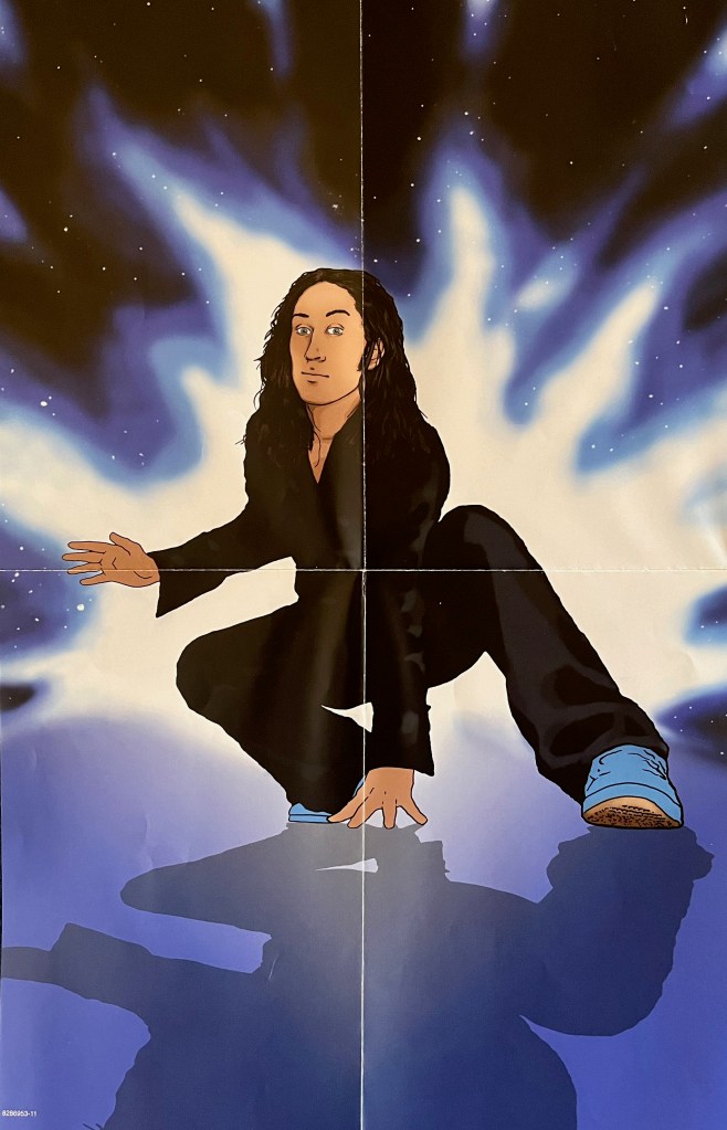 A fold-out poster from Ross Noble's Headspace Cowboy DVD, showing a cartoon version of him squatting down in a martial arts type pose, with legs slightly apart, one hand on the ground in front of him, and the other hand held out to the side.