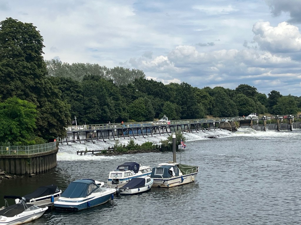 Teddington Weir, with a long walkway over the wide expanse of gushing water.