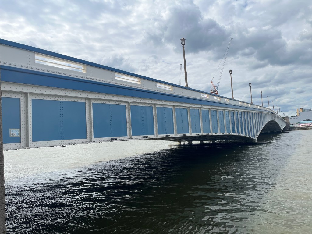 Close-up view of the steel structure of Wandsworth Bridge, with blue panels surrounded by white framing.