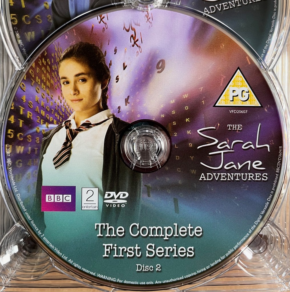 Series 1 Disc 2 from the DVD box set of The Sarah Jane Adventures, including a photo of Maria, a young white girl in a school uniform.
