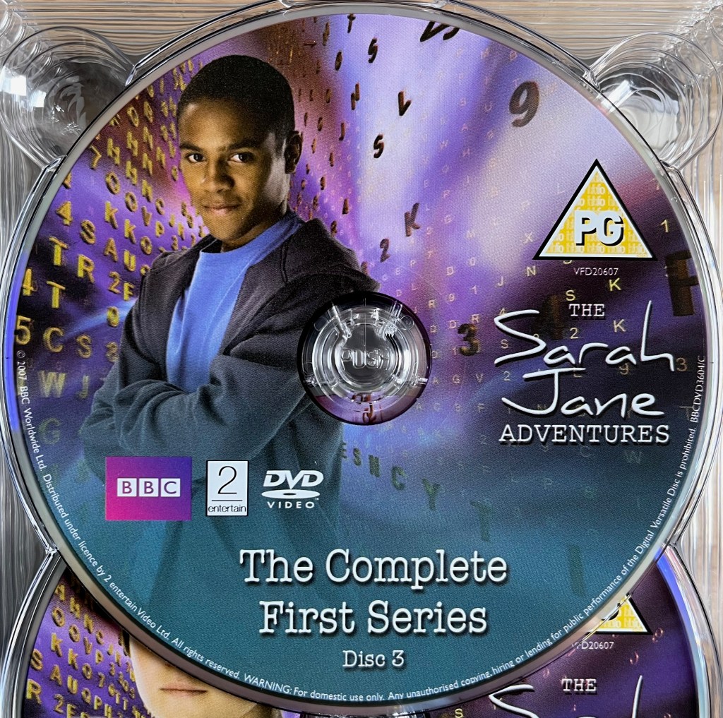 Series 1 Disc 3 from the DVD box set of The Sarah Jane Adventures, including a photo of Clyde, a young black boy.