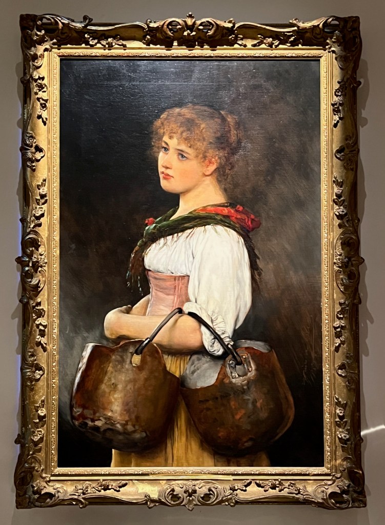 Oil on canvas painting by Eugen von Blaas called The Water Carrier. It depicts a young Venetian woman posing in contemporary costume that has puffy and short white sleeves, with two copper kettles resting on her arm, while a colourful red and green shawl is draped over her shoulders.