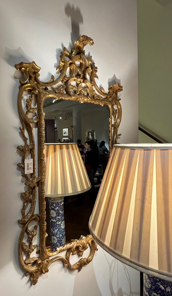 A George III mirror with a very elaborate and ornate gold frame.