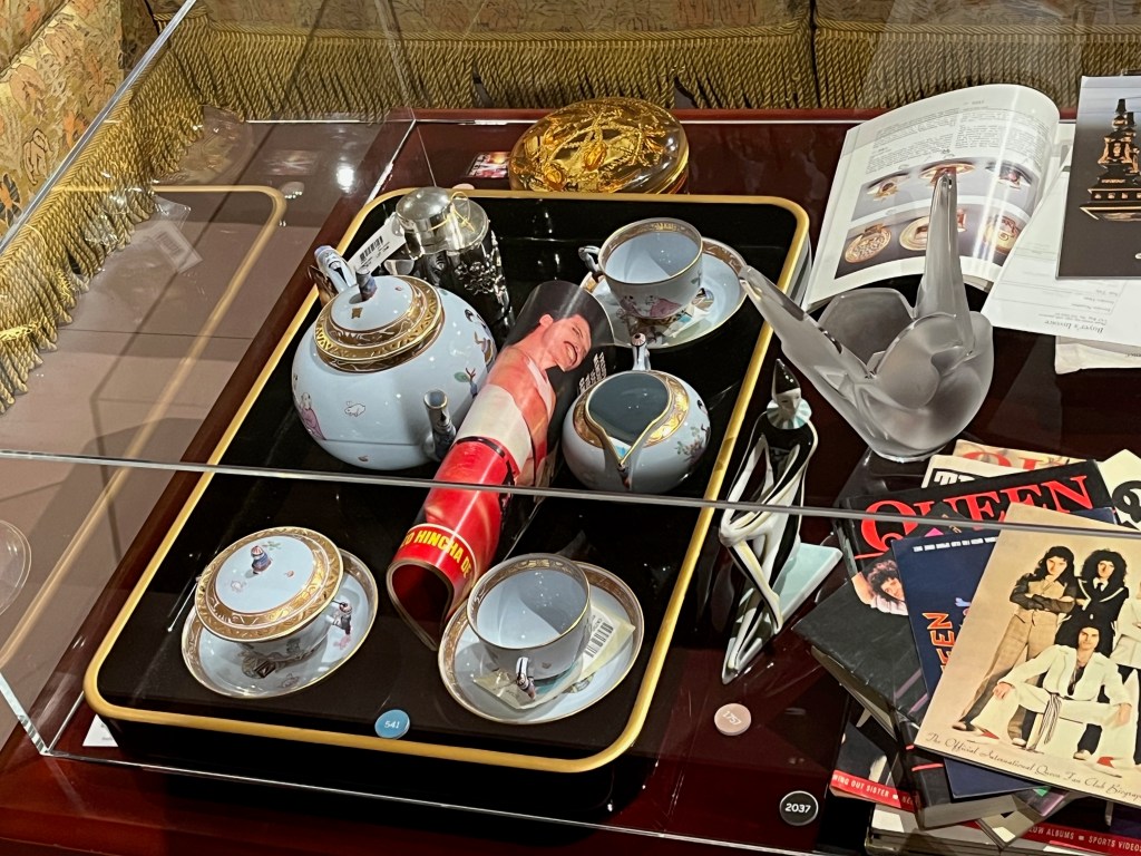 A porcelain tea service, each piece painted with figures on a pale lavender background with gilded borders and pierced gilded collared feet.