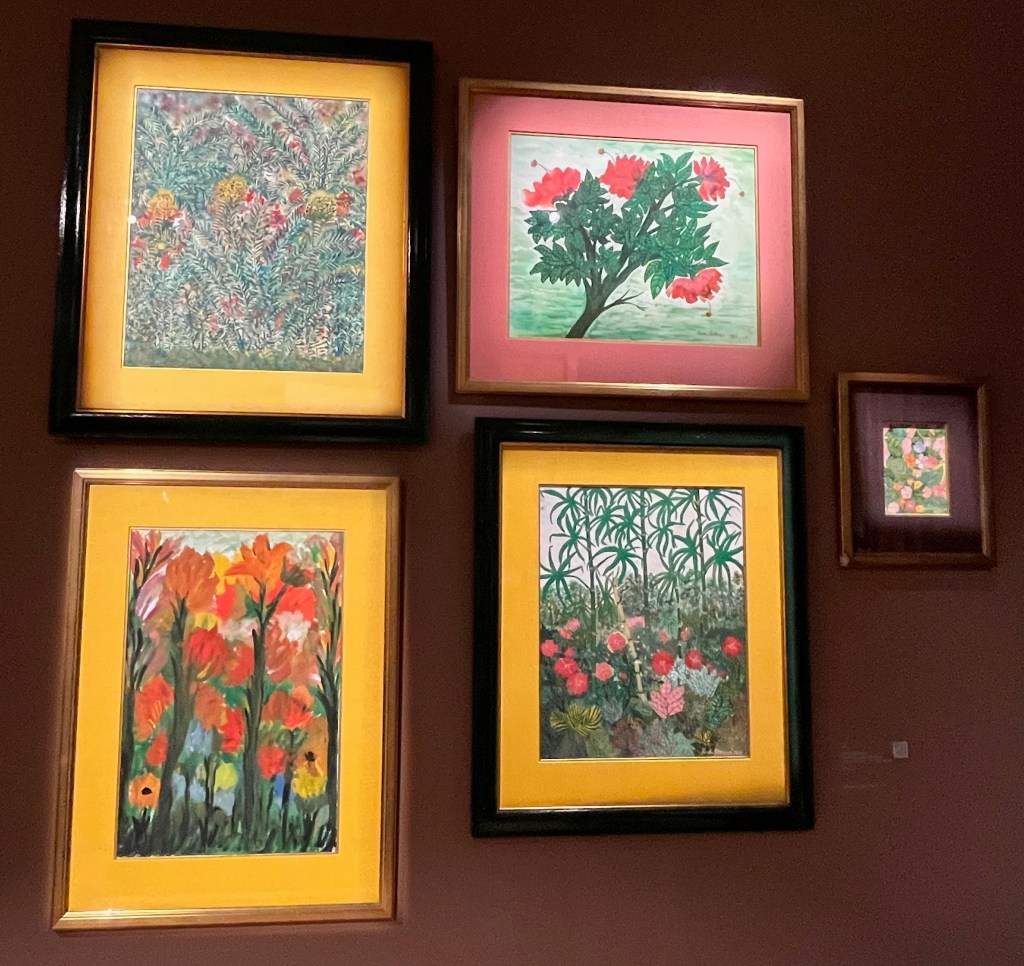 A set of 5 paintings, four of which are a similar large size to one another, while the 5th is tiny in comparison. They depict colourful scenes of tropical plants, flowers and trees.