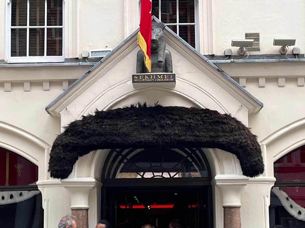 A large black Freddie Mercury style moustache over the doorway of Sotheby's.