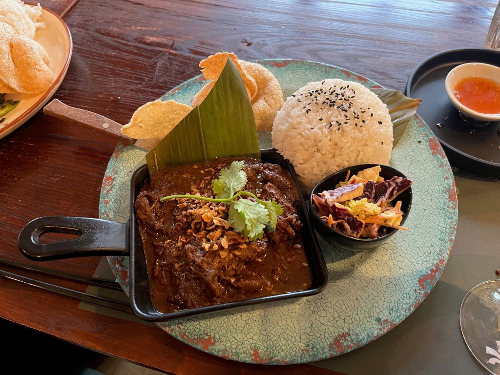 Beef Rendang Curry with a large ball of jasmine rice.
