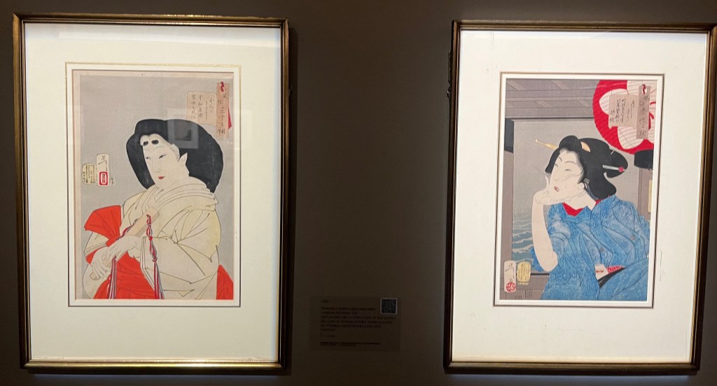 2 Japanese woodblock prints by Tsukioka Yoshitoshi, showing a refined lady wearing cream and red robes, and a geisha lady dressed in a light blue robe.