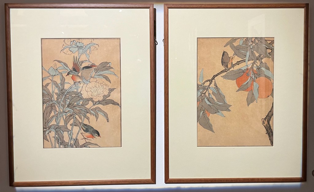 Two Japanese woodblock prints depicting birds perched on branches and stems amongst flowers and foliage.