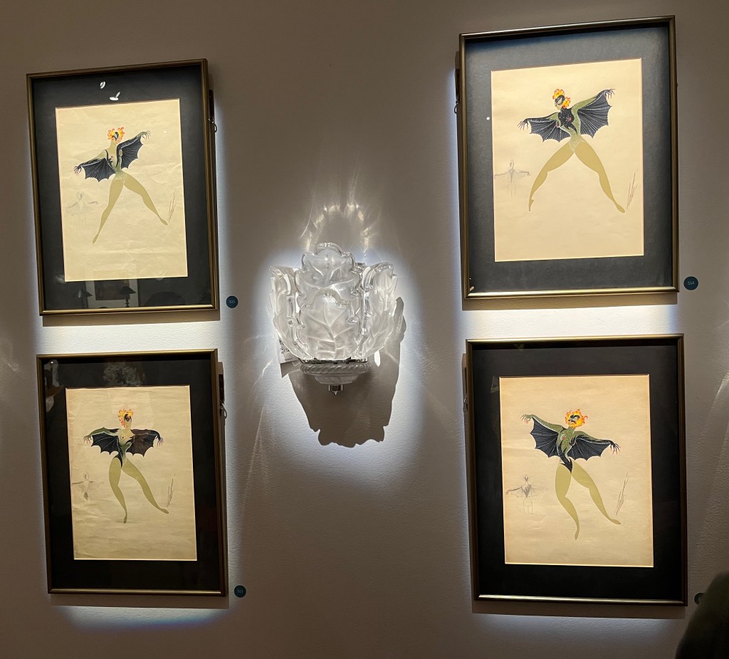 4 paintings by French artist Erté. They all show the same dancer, with blonde hair and wearing a black eye mask and a skin-tight leonard on their very slim frame. In each artwork, their arms are stretched out to the sides as they move, with large bat wings attached.