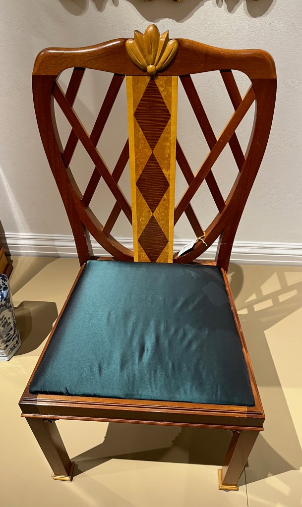 Mahogany and maple dining chair designed by Robin Moore Ede, with a lattice style back, on which is a motif of 3 red diamonds on a yellow background going down the centre.