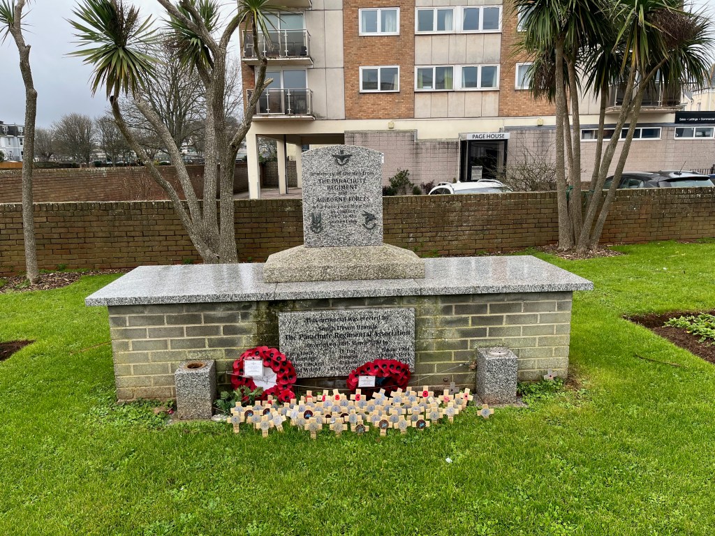 Stone memorial to the Parachute Regiment and Airborne Forces, consisting of a plinth on top of a much wider base section. The inscription on the top and bottom sections reads In memory of the men from the Parachute Regiment and Airborne Forces who have given their lives in Conflict, 1940 to the present day. This memorial was erected by South Devon branch The Parachute Regimental Association. Unveiled on 28th March 2010 by Harry Leach, D-Day, 6 June 1944, Ted Burridge, Arnhem 17 September 1944, Dennis Crocken, Arnhem 17 September 1944, and Harold Wright, Rhine Crossing, 24 March 1945.
