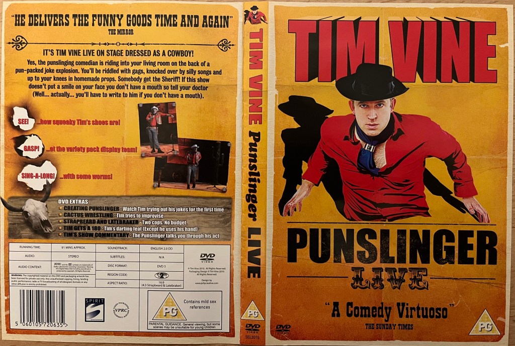DVD cover spread for Tim Vine, Punslinger. The front shows him wearing a cowboy outfit including a black hat and red shirt, the shirt slightly open to reveal his hairy chest. The back shows a couple of photos from him during the show.