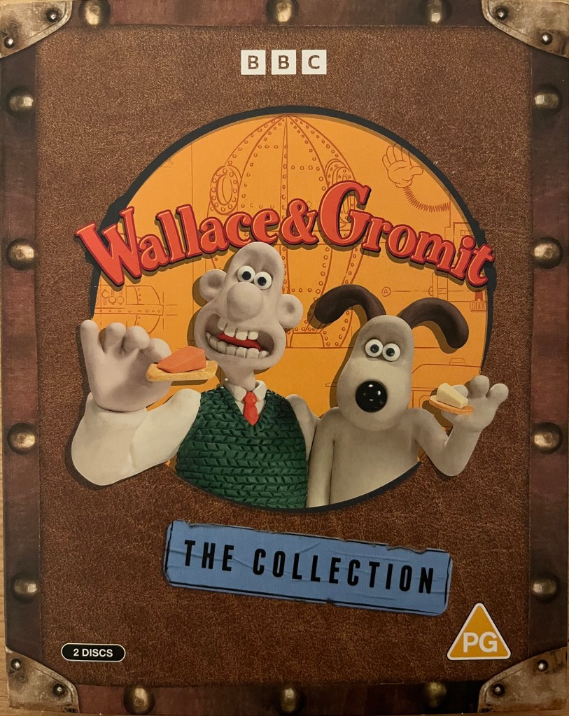 Front cover of the Wallace & Gromit Collection Blu-ray, showing the two plasticine characters standing at a large round porthole, each holding a cracker with a lump of cheese on it.