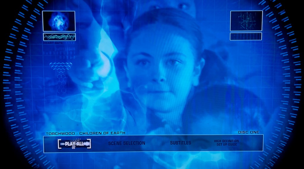 Blu-ray menu for Torchwood, Children Of Earth, showing a blue-tinted image of a little girl. The options along the bottom are Play All, Scene Selection, Subtitles and High Definition Set Up Guide.