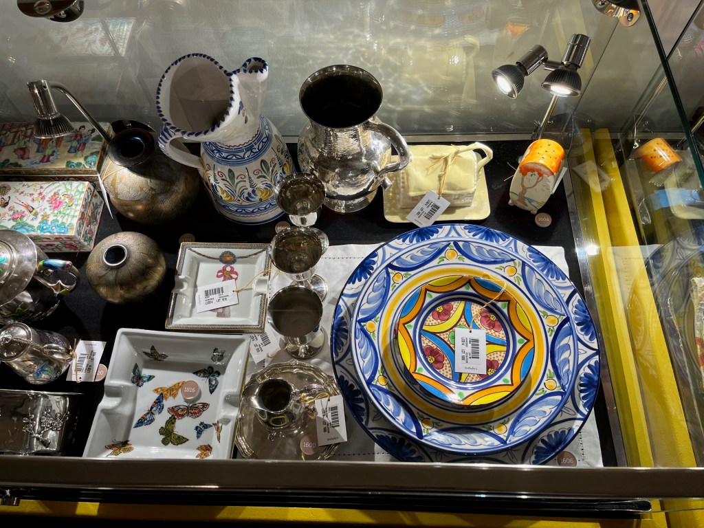 A selection of small objects in a glass case in the Freddie Mercury exhibition.