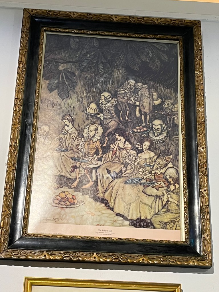 A painting of a group of women in large dresses, along with a very thin looking man wearing an outfit with a large ruffled collar, enjoying refreshments being given to them by servants who are wearing large ruffs around their necks as part of their outfits.