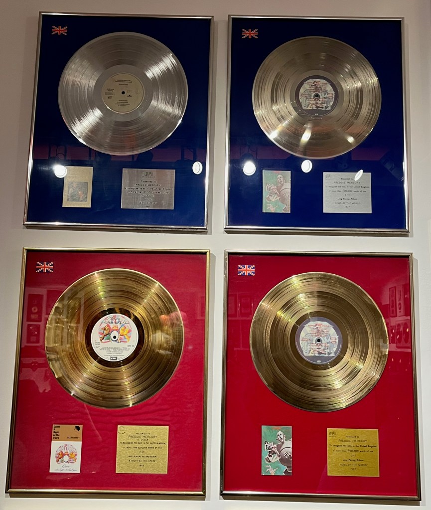 2 large silver and 2 large gold disc awards. The silver awards are for the albums Barcelona and News Of The World, while the gold awards are for the albums A Night At The Opera and News Of The World.
