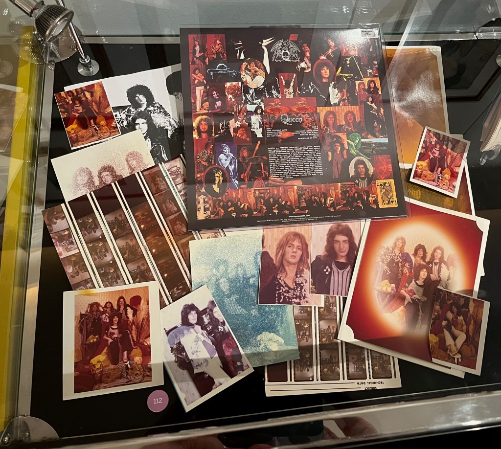 Collection of photographs of the band Queen, and the back of their debut album on which many of the photos are used.