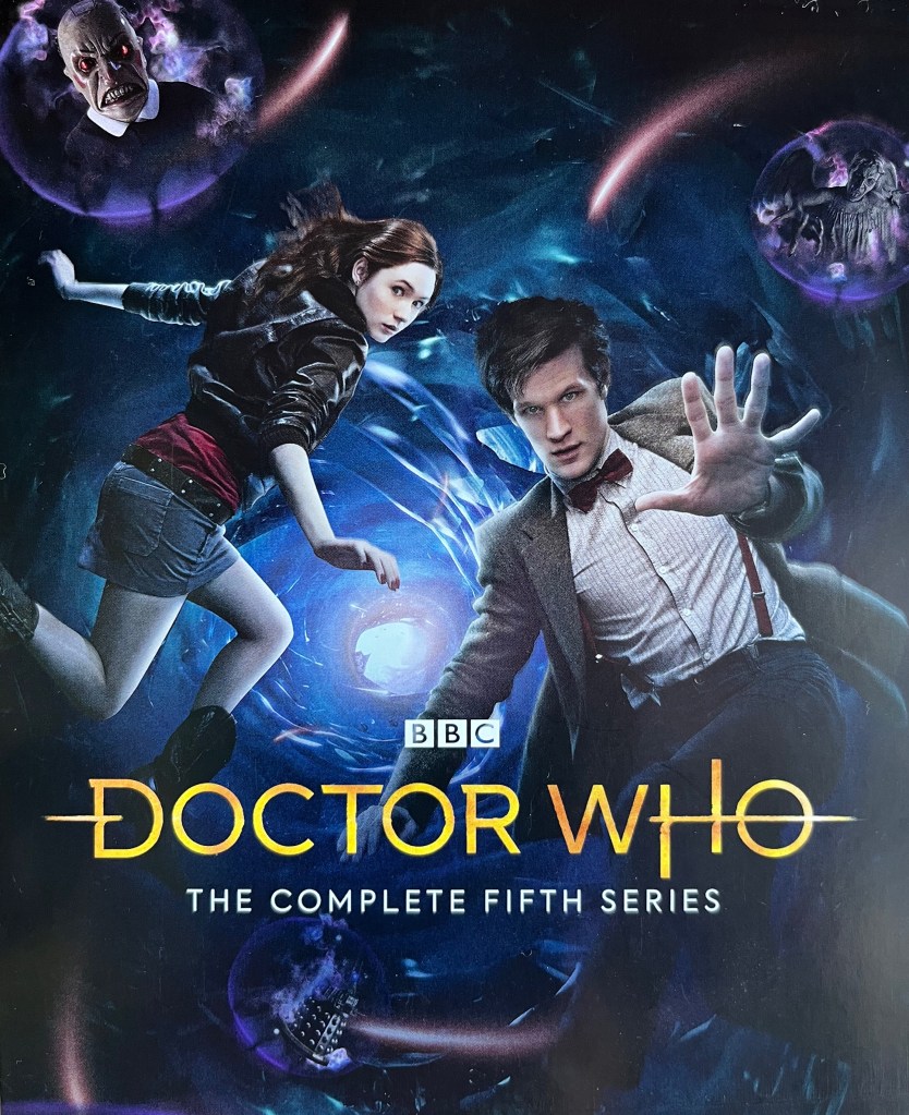 Front of the leaflet included with the Doctor Who Series 5 Blu-ray set, showing Matt Smith's Doctor and companion Amy Pond falling through the vortex, while enemies including a Weeping Angel and Daleks watch on from the sidelines.