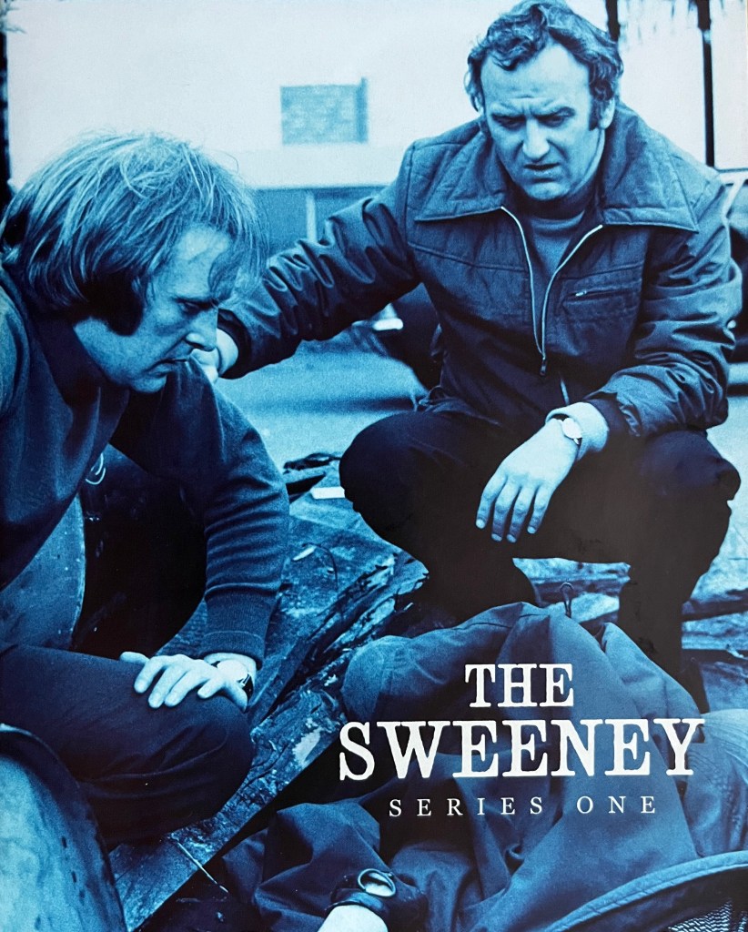 Front cover of the booklet included in the Blu-ray boxset for The Sweeney Series 1. It shows a blue-tinted image of Regan and Carter squatting as they look at a dead body on the ground.