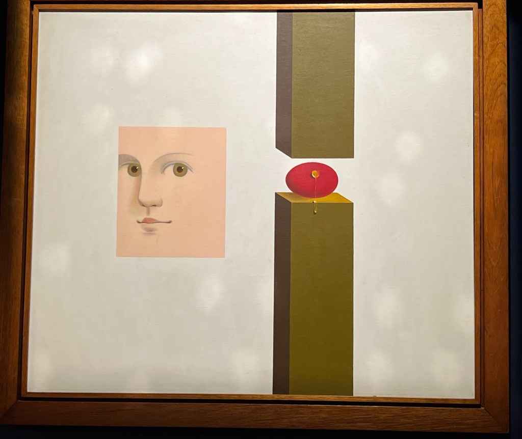 A painting that shows a face with big green eyes in a square, alongside a red apple sitting on a wooden post, with another wooden post pointing downwards close above it.