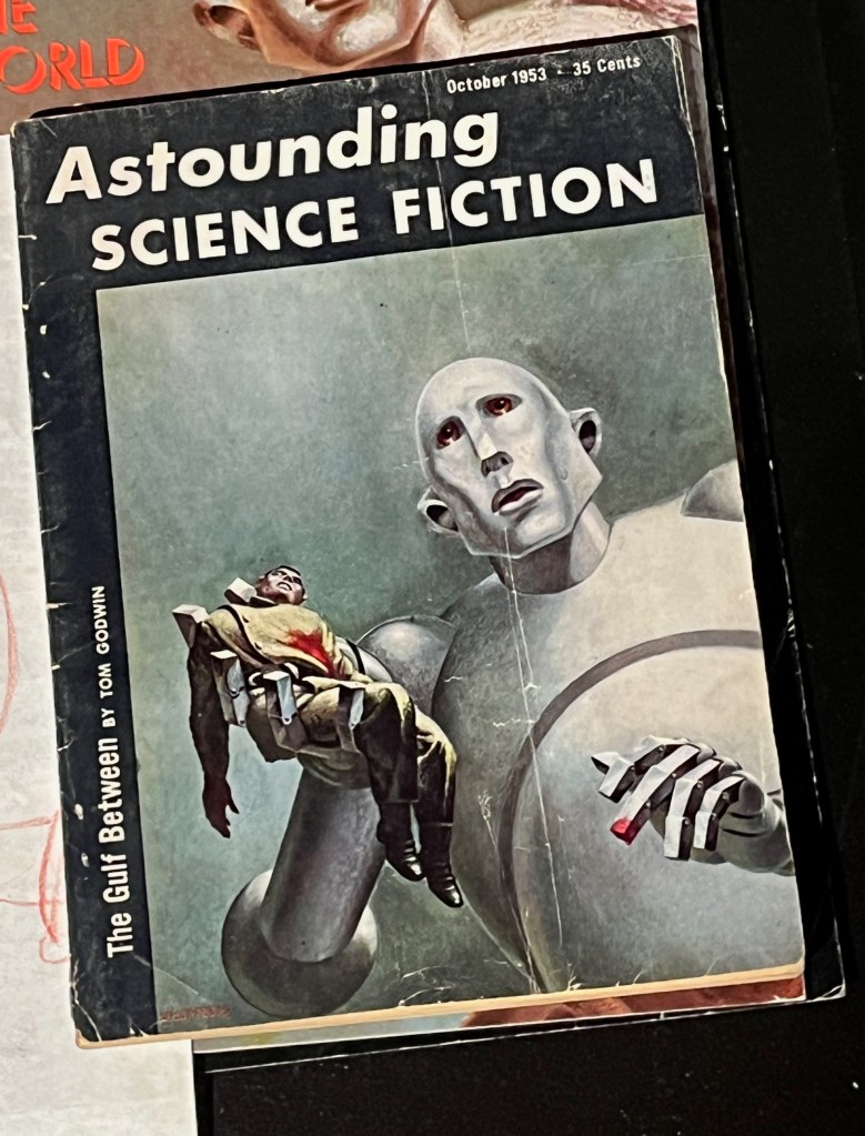 A book called Astounding Science Fiction, the cover showing an image of a huge robot carrying an unconscious man in its hand. This image was adapted by Queen to become the cover of their album News Of The World.