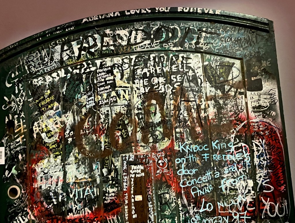 Close-up of fan graffiti in tribute to Freddie Mercury on the large green door to Garden Lodge.