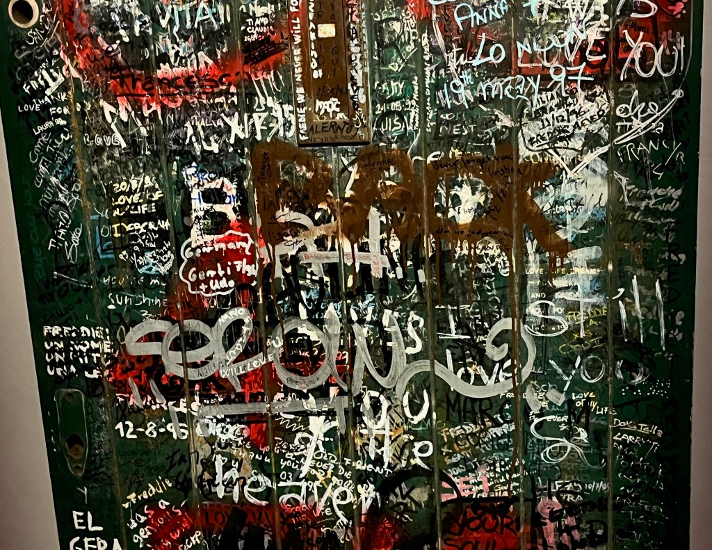 Close-up of fan graffiti in tribute to Freddie Mercury on the large green door to Garden Lodge.