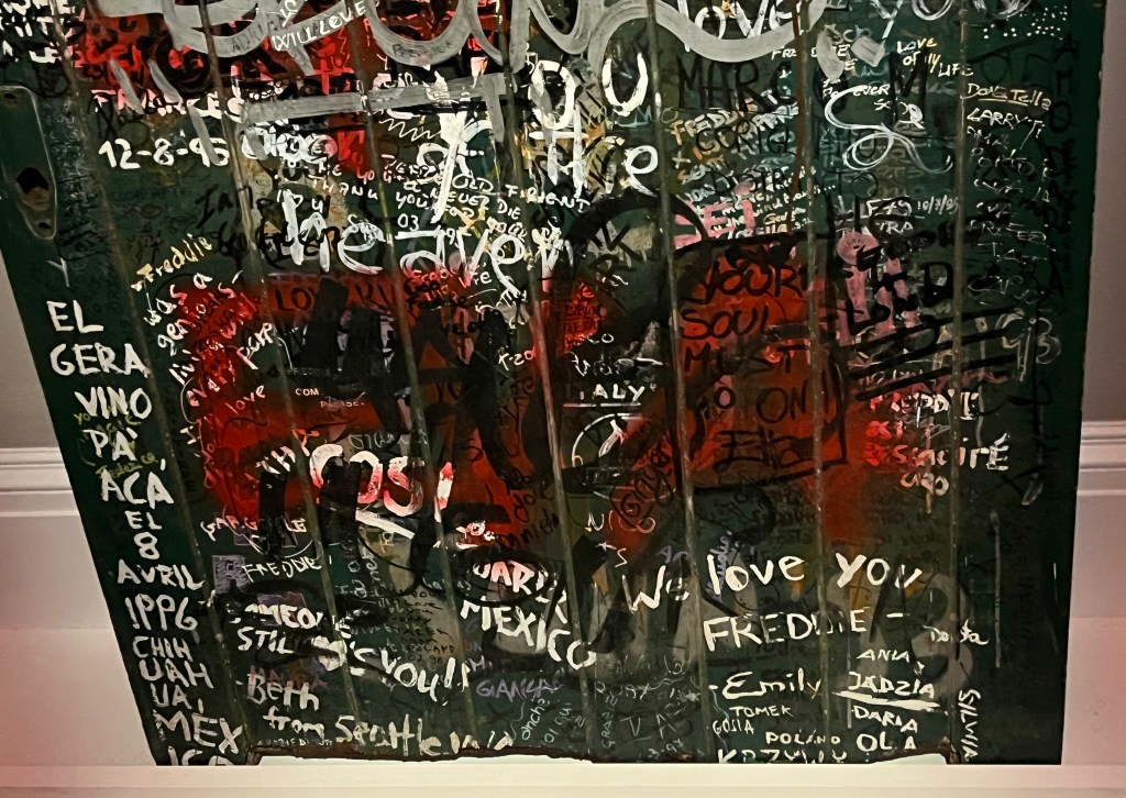 Close-up of fan graffiti in tribute to Freddie Mercury on the large green door to Garden Lodge.