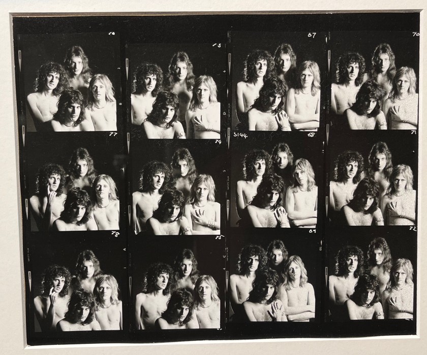 A sheet of 12 black and white photos of the band Queen posing together in the nude, only looking at the top halves of their bodies. The photos appear identical at first glance, but there are subtle differences in aspects like facial expressions.