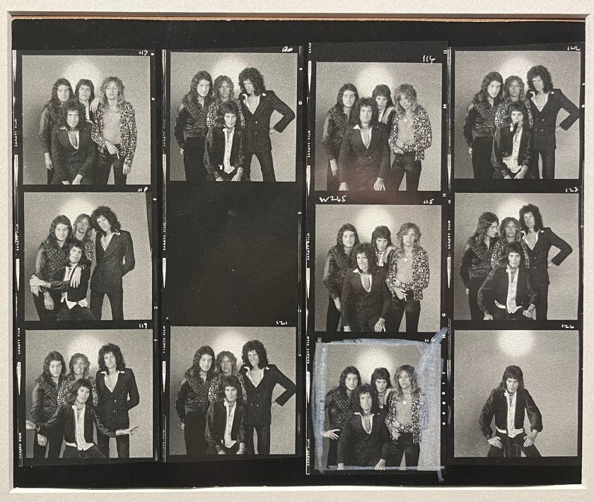 A sheet of 11 black and white photos of the band Queen posing together. In most cases, Freddie Mercury is in front, while the other 3 are posing behind him. But there is one instance where Brian is in front and Freddie is with John and Roger behind him. And there is one photo of Freddie on his own.