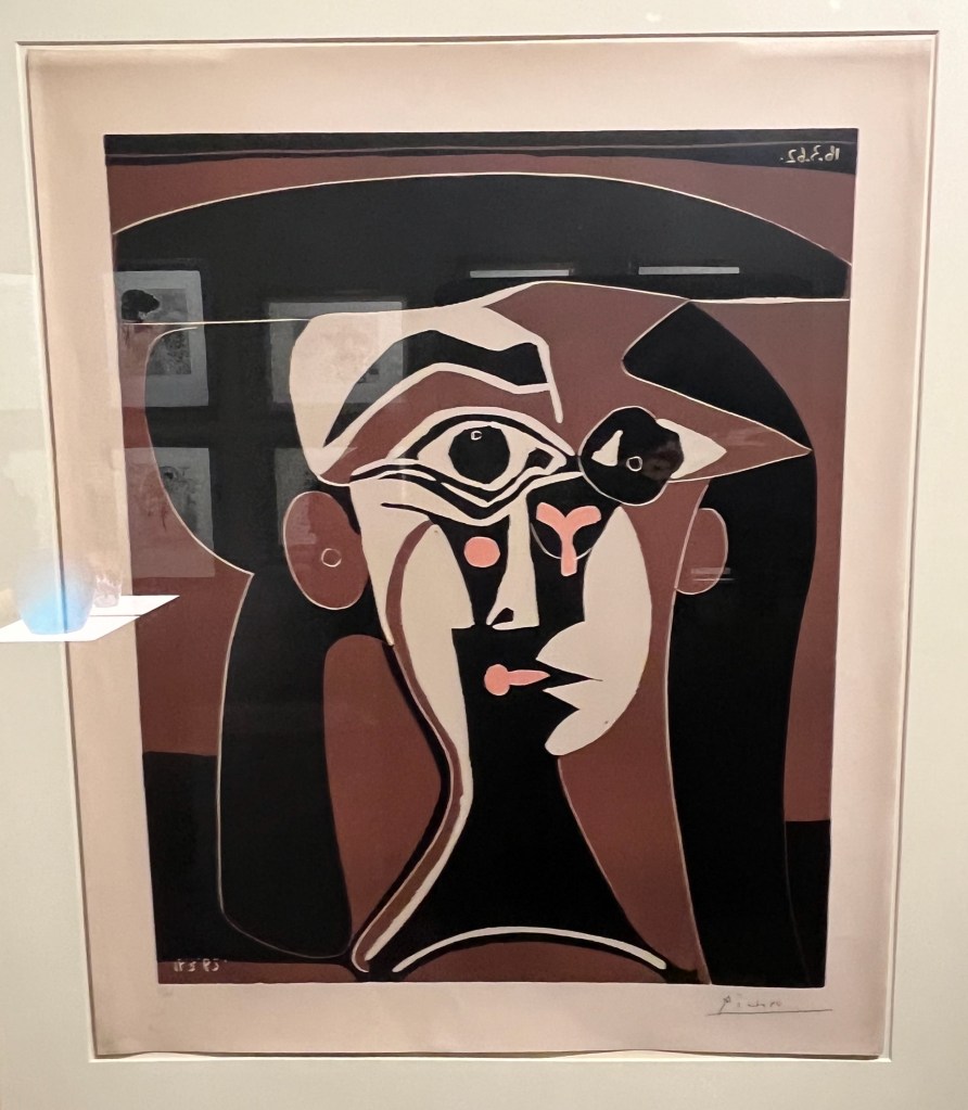 A print by Pablo Picasso called Jaqueline au chapeau noir, with a heavily morphed representation of a woman's face.